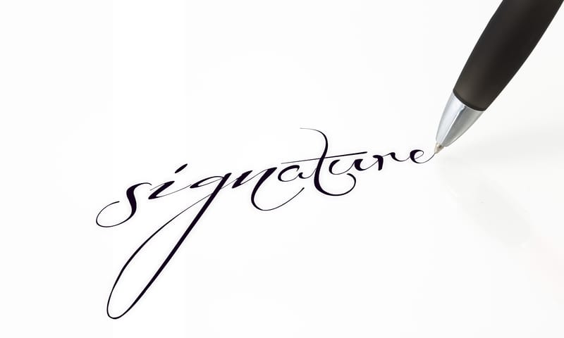 Close-up of a pen writing a fluid cursive signature on a clean white paper to demonstrate compliance with the USCIS signature rule 2026